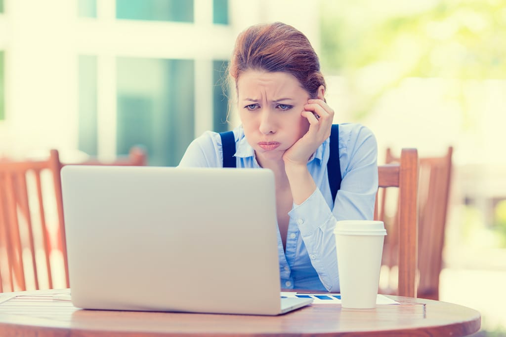 woman frustrated over her free website looking at her laptop