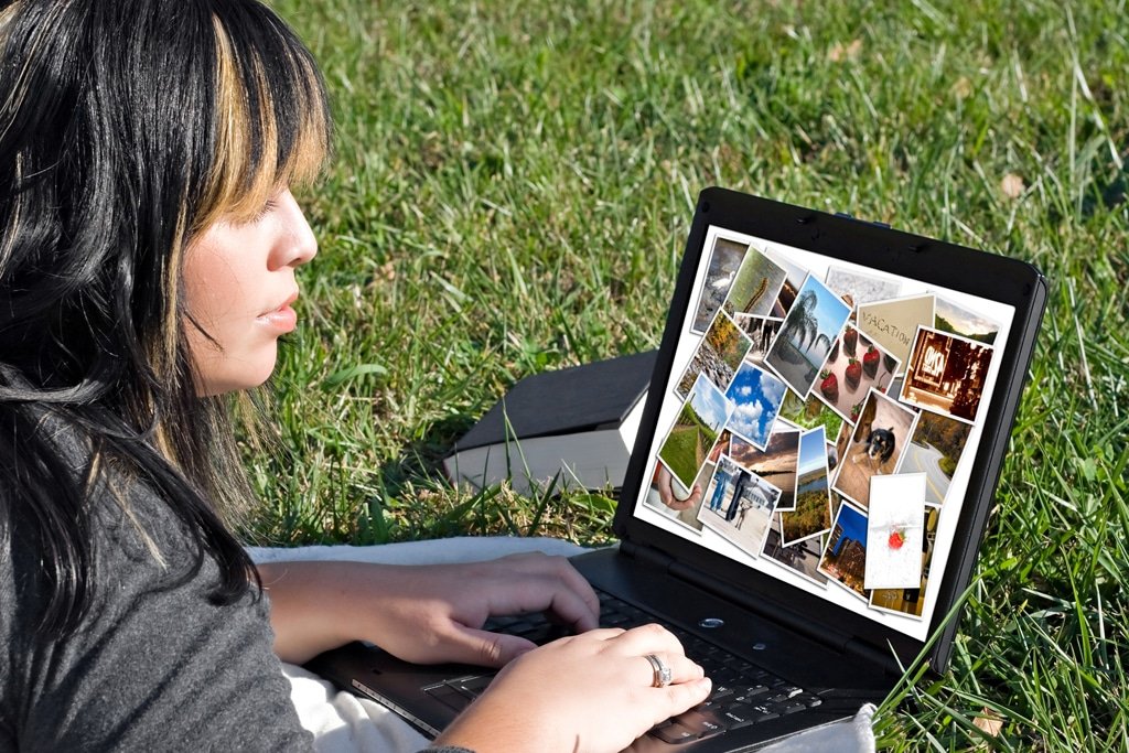 Woman on her laptop looking at Website Photos