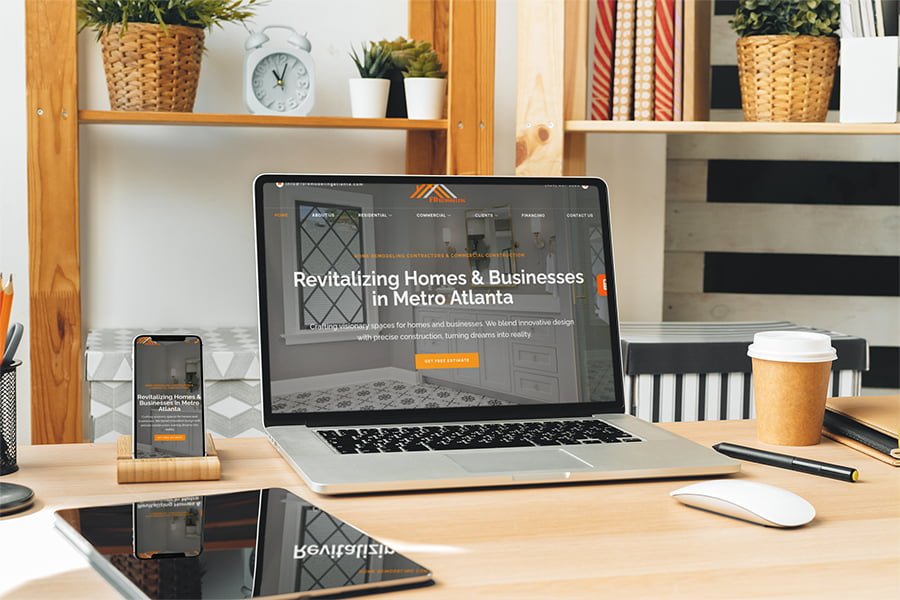 A remodeled desk with a laptop, phone and tablet.