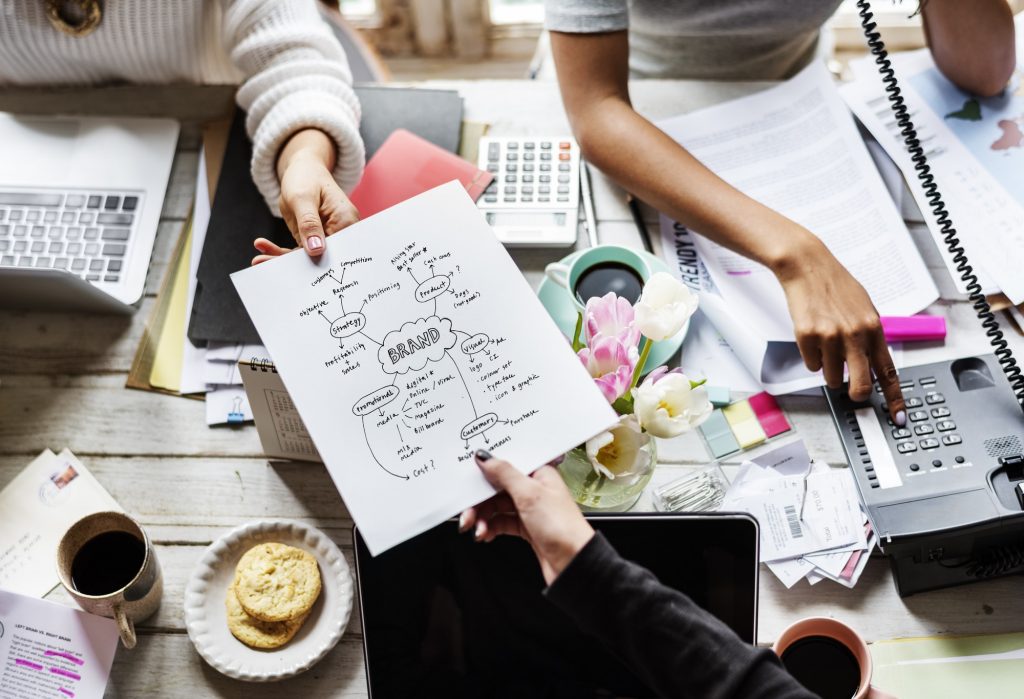 How to Create A Branding Guide for Your Plumbing or HVAC Business 3 colleagues-handing-branding-plan-strategy-to-other.jpg
