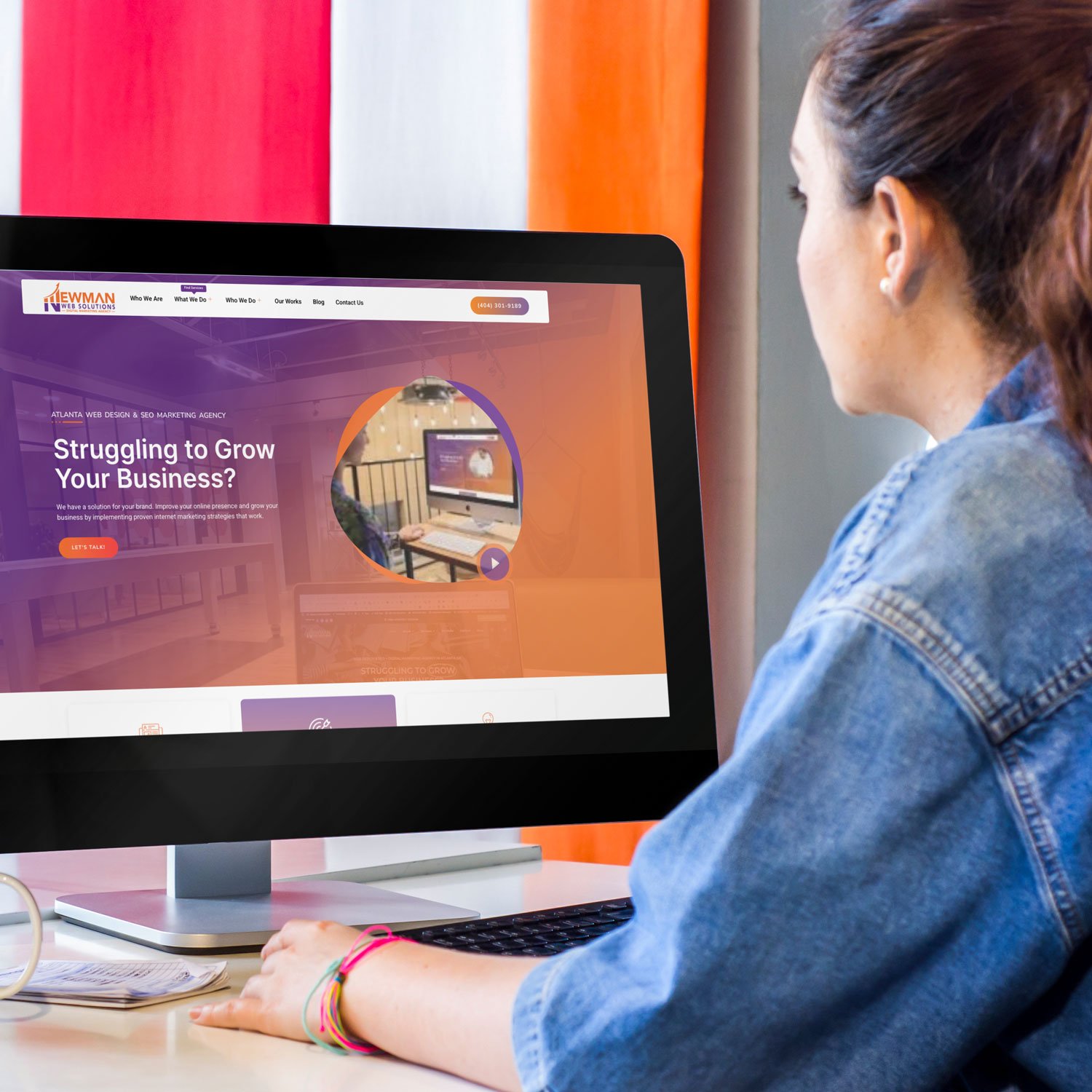 A digital marketing expert sitting in front of a computer screen with a website on it.