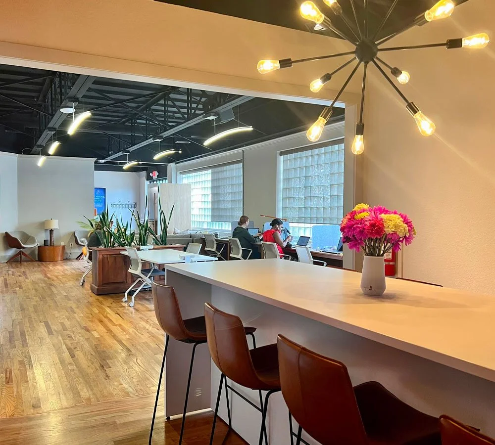The entrance to Newman Web Solutions Agency with tables and desks for digital marketing experts.