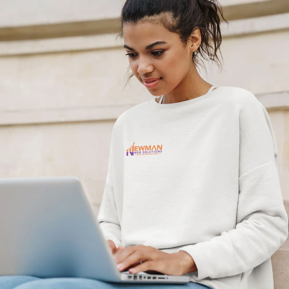 A marketing expert engrossed in digital strategies, sitting on a bench with a laptop on her lap.