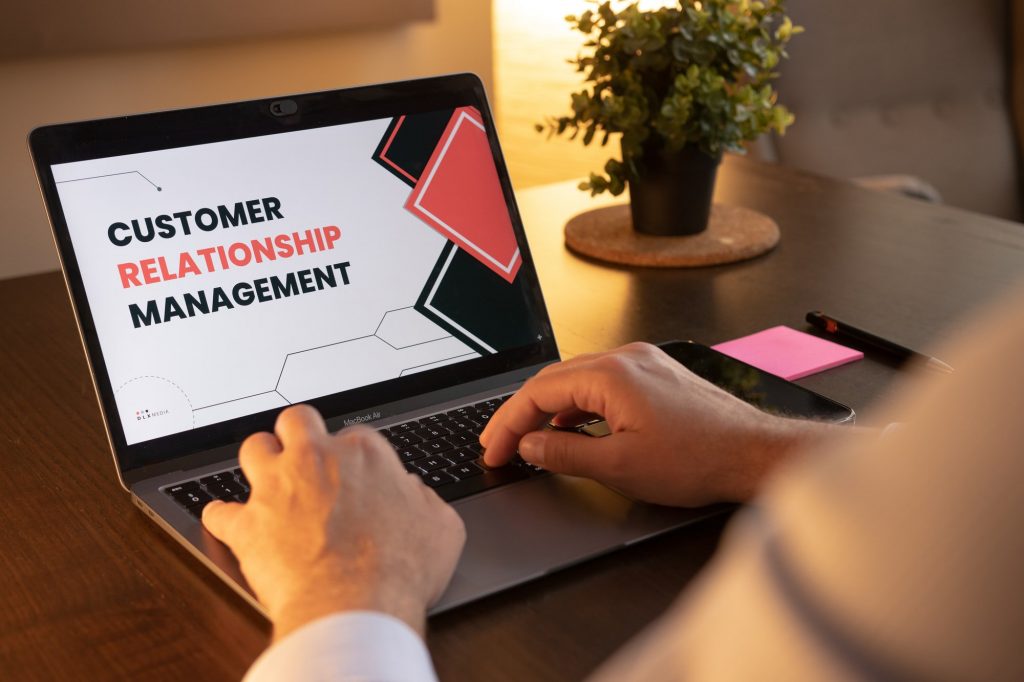 A man utilizing marketing CRM software on his laptop.