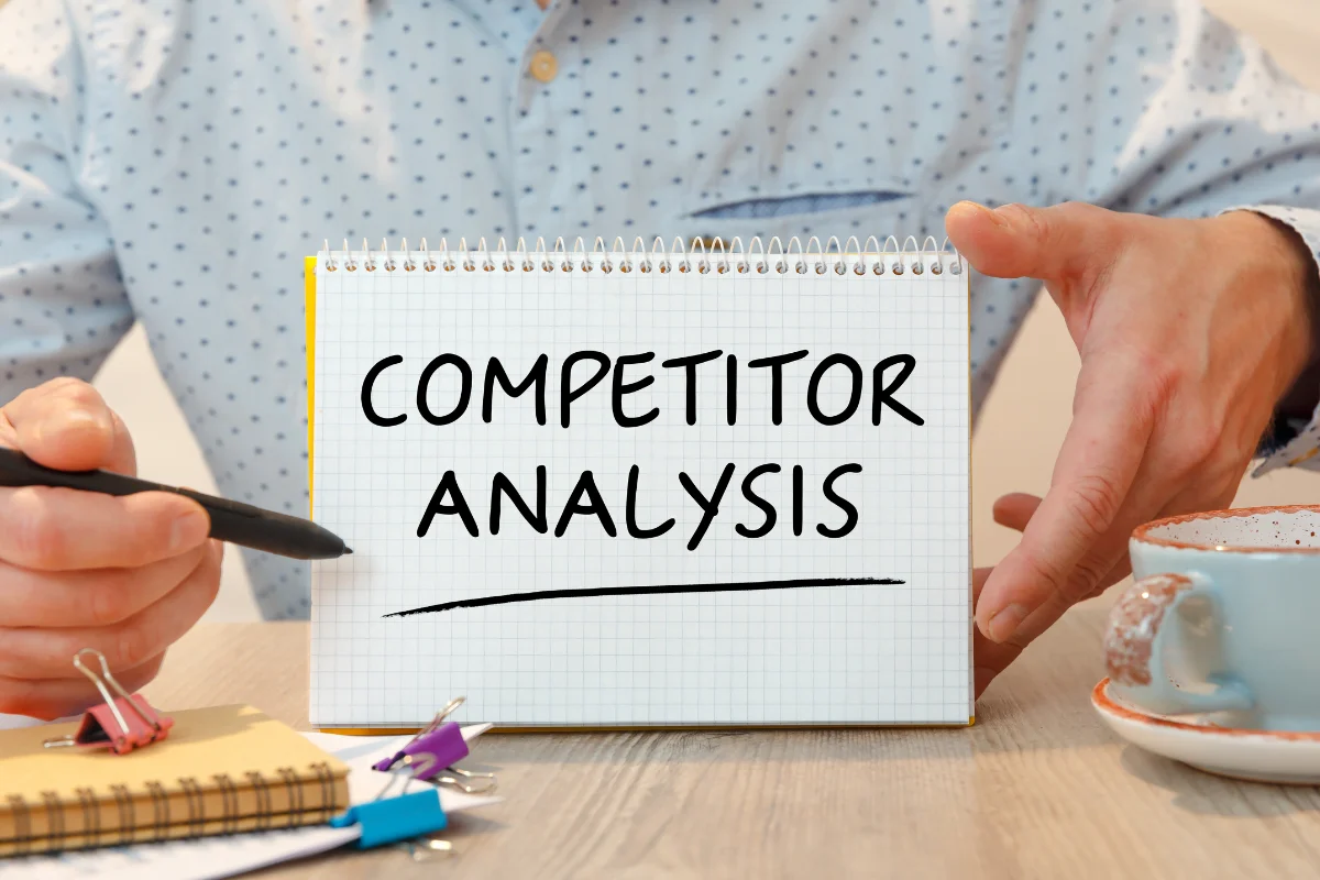 SEO Competitor Analysis: Unveiling The Secrets To Outrank Your Rivals 10 A man conducting SEO competitor analysis and showing it on a piece of paper.