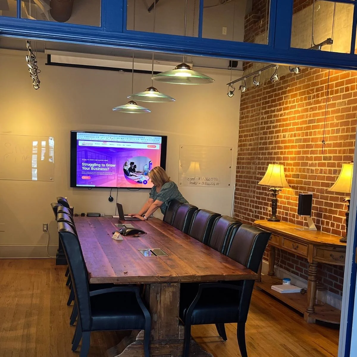 Acworth Web Design 1 A conference room with a large table and a TV offering Acworth marketing services.