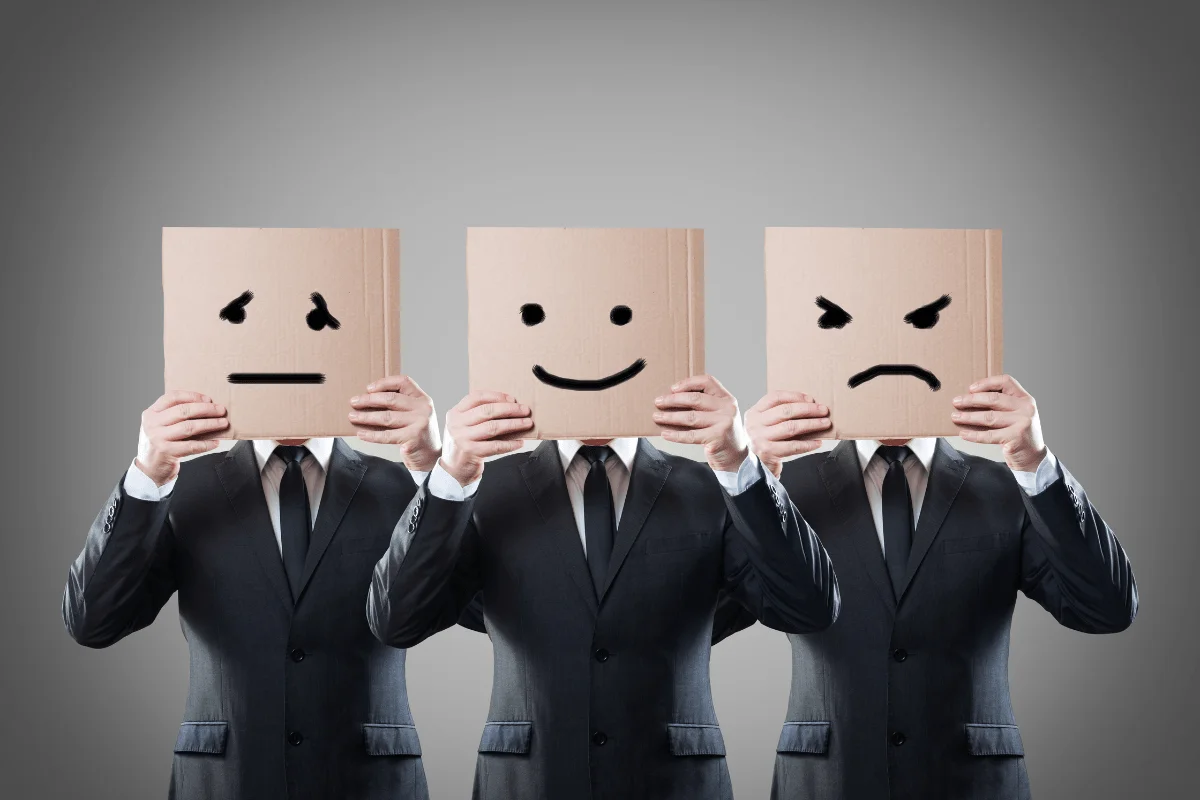 Copy That Converts: The Power Of Persuasive Writing Techniques 3 A group of businessmen holding up paper with smiley faces on it.