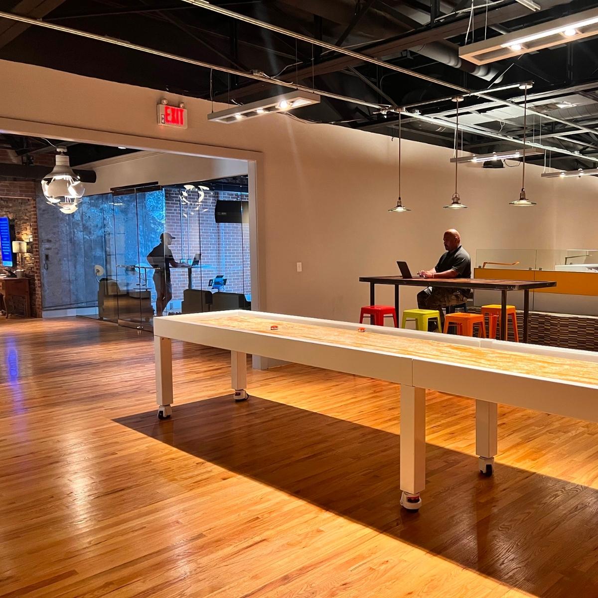 An office featuring a shuffleboard table.