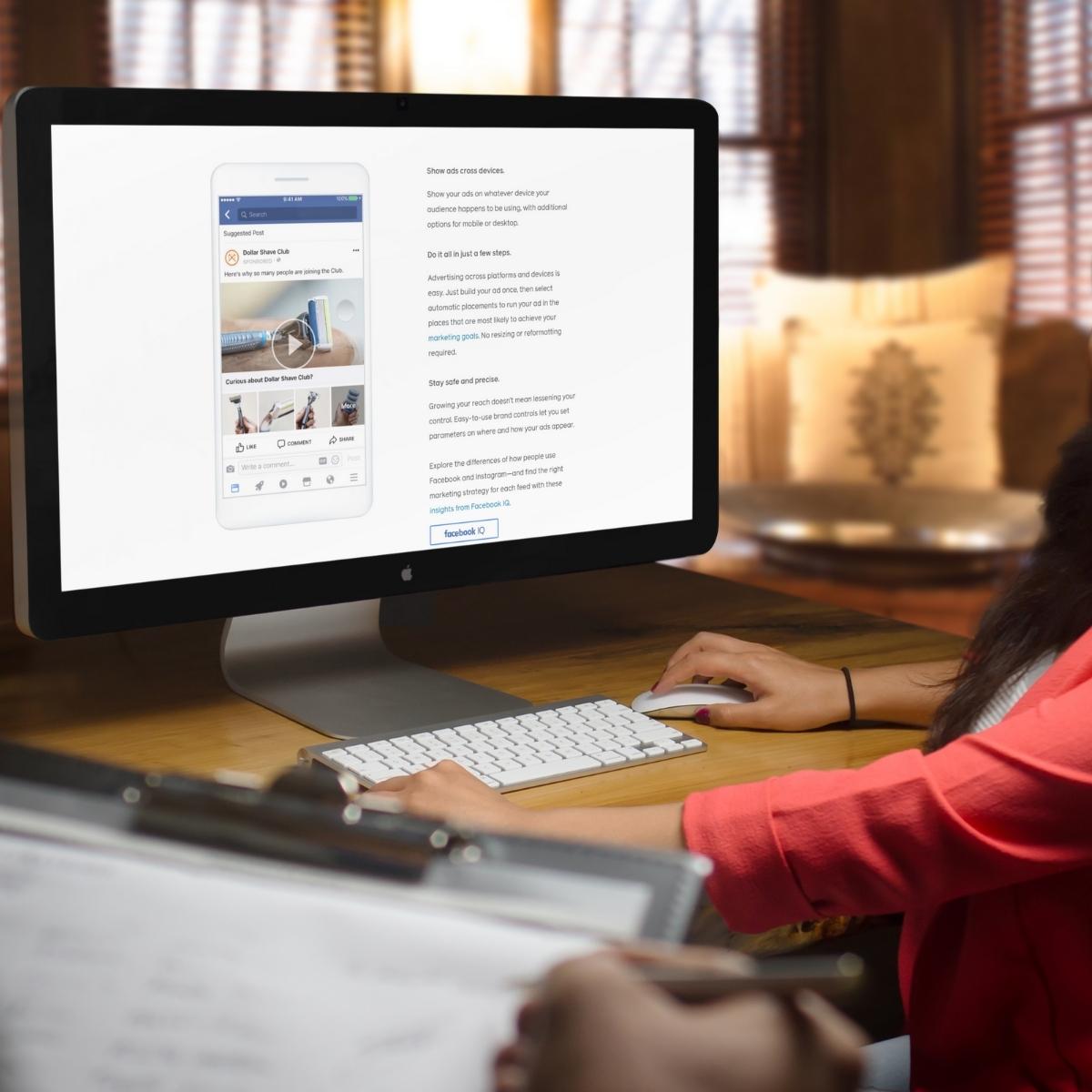 A woman is using a computer screen to manage a Facebook advertising campaign.