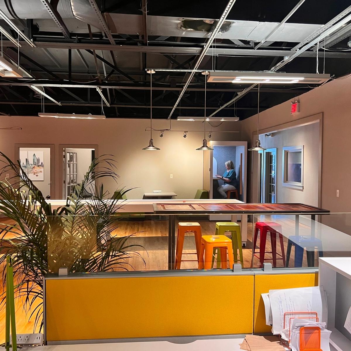 A vibrant office with stools and a plant, perfect for Kennesaw web design.