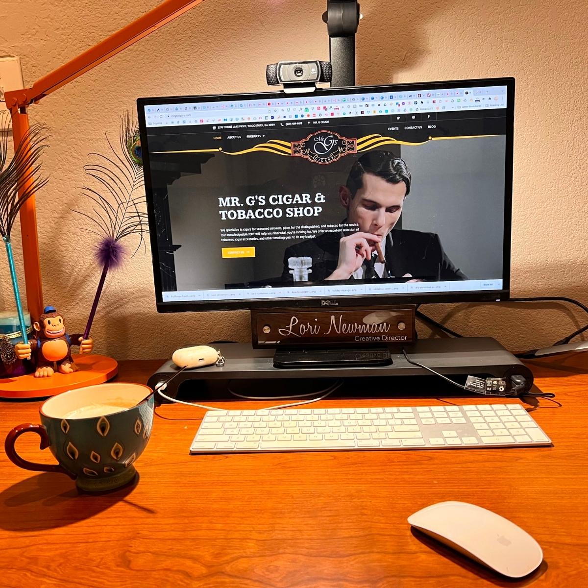 A desk with a computer and a cup of coffee in a woodstock office.