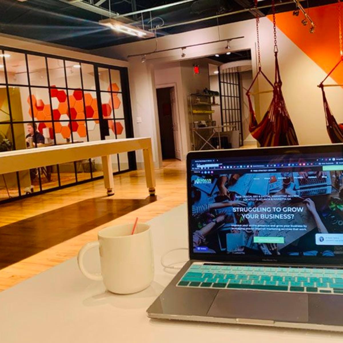 A laptop conducts a wordpress website audit on a desk in an office.