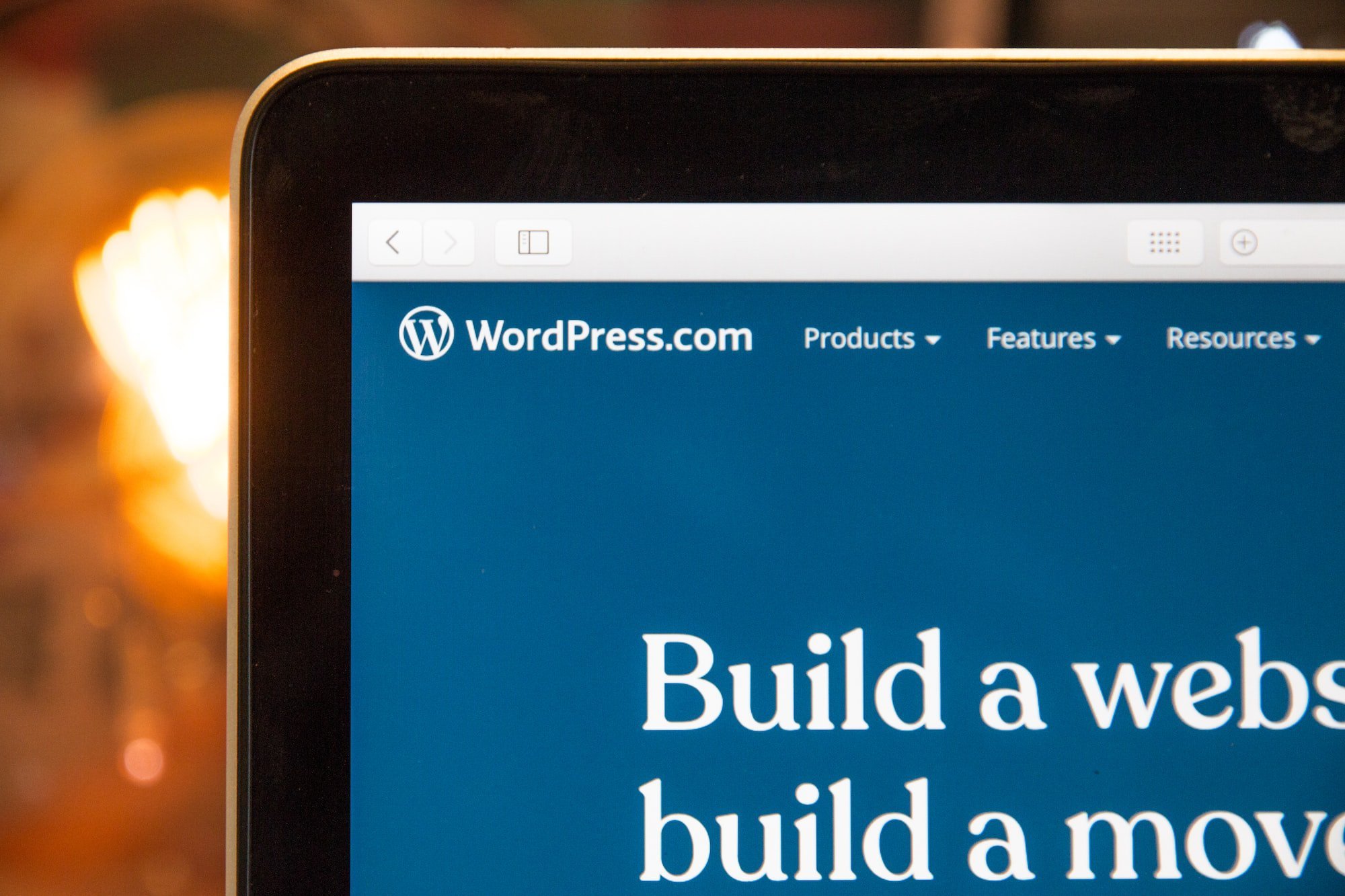 The wordpress website's navigation menu is displayed on a laptop.