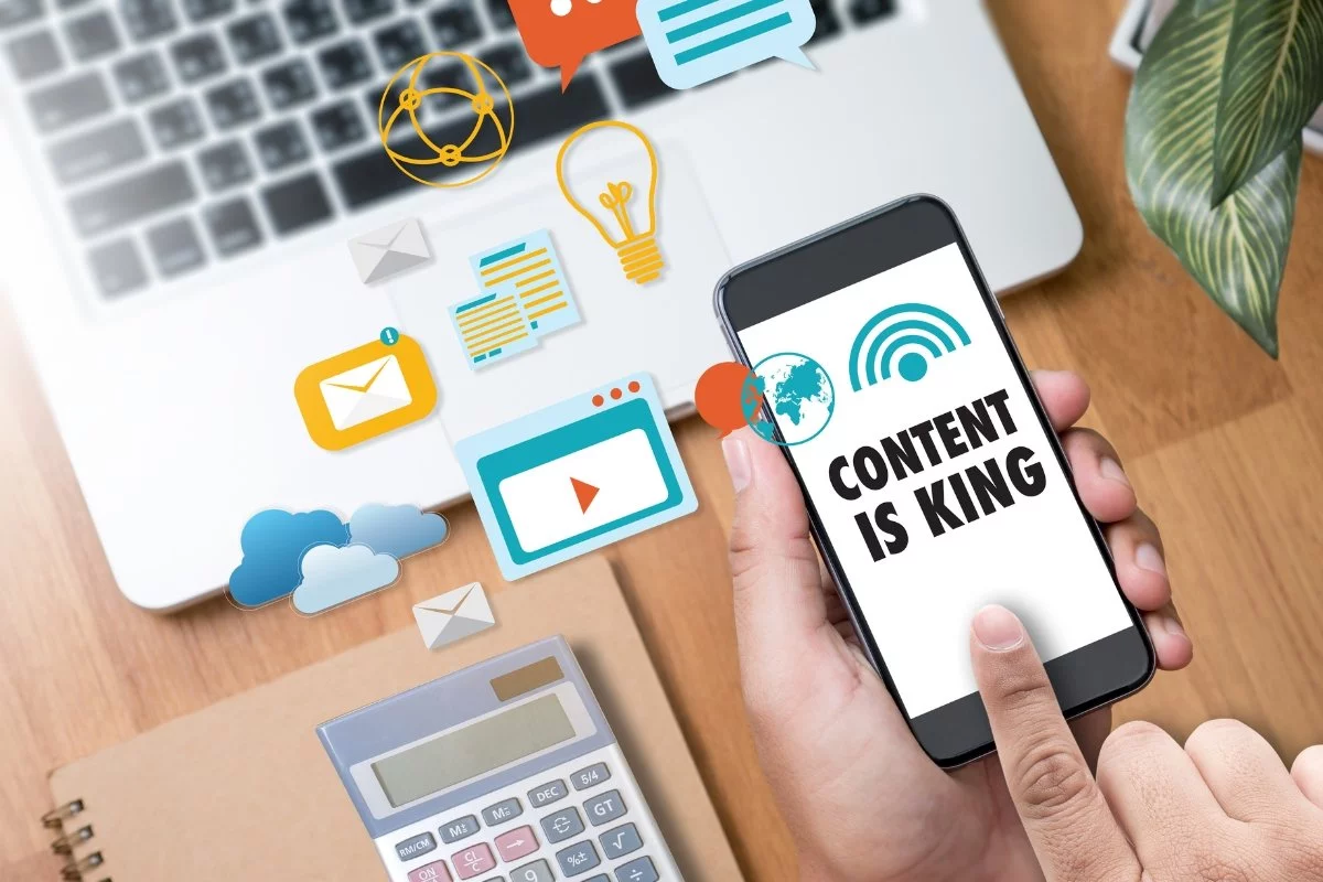 Content Is King in SEO: How Stellar Stories Secure Top Spots 9 A person demonstrating content syndication by holding a phone with the word "content" on it.