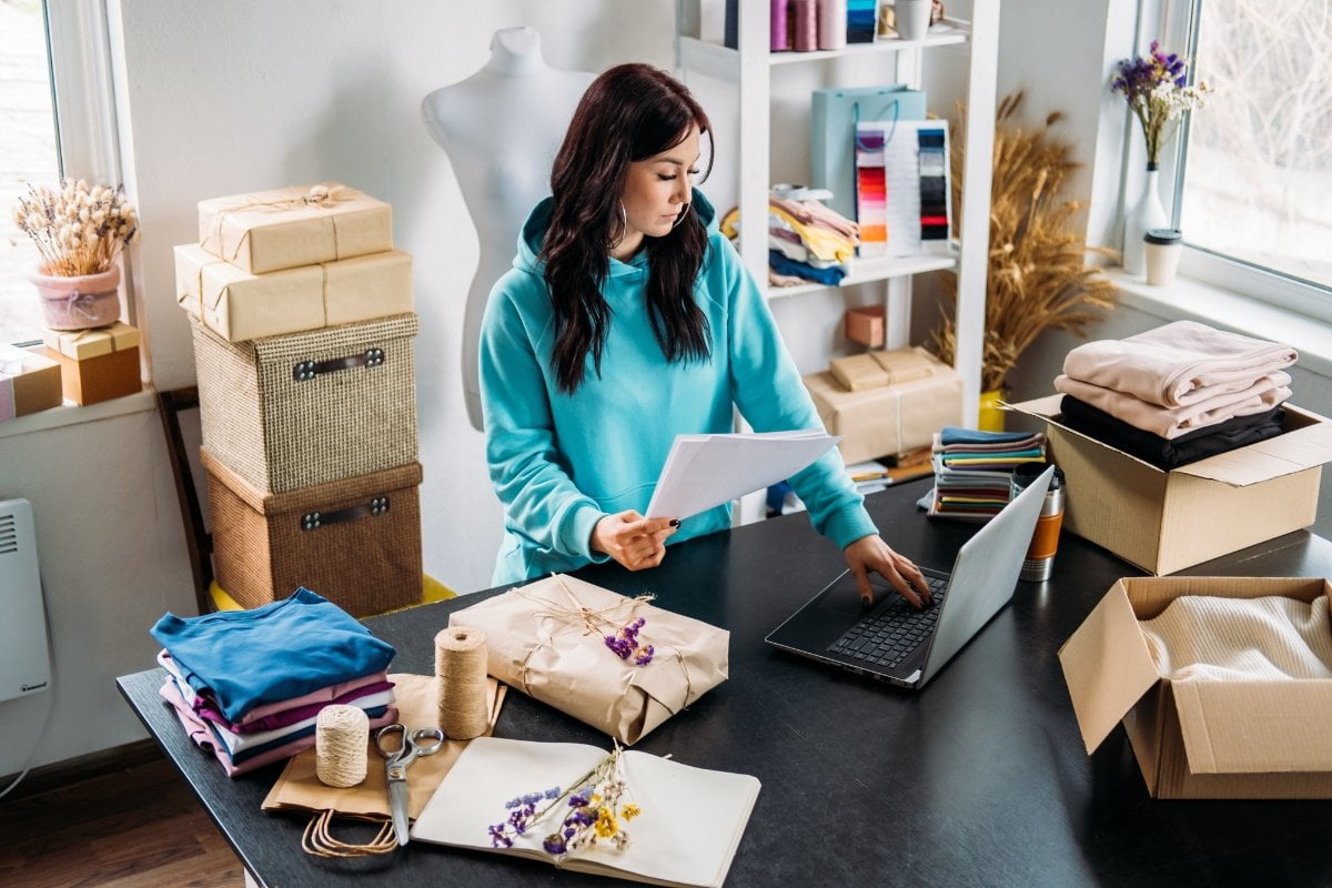 A woman is optimizing websites for small businesses from her home office.
