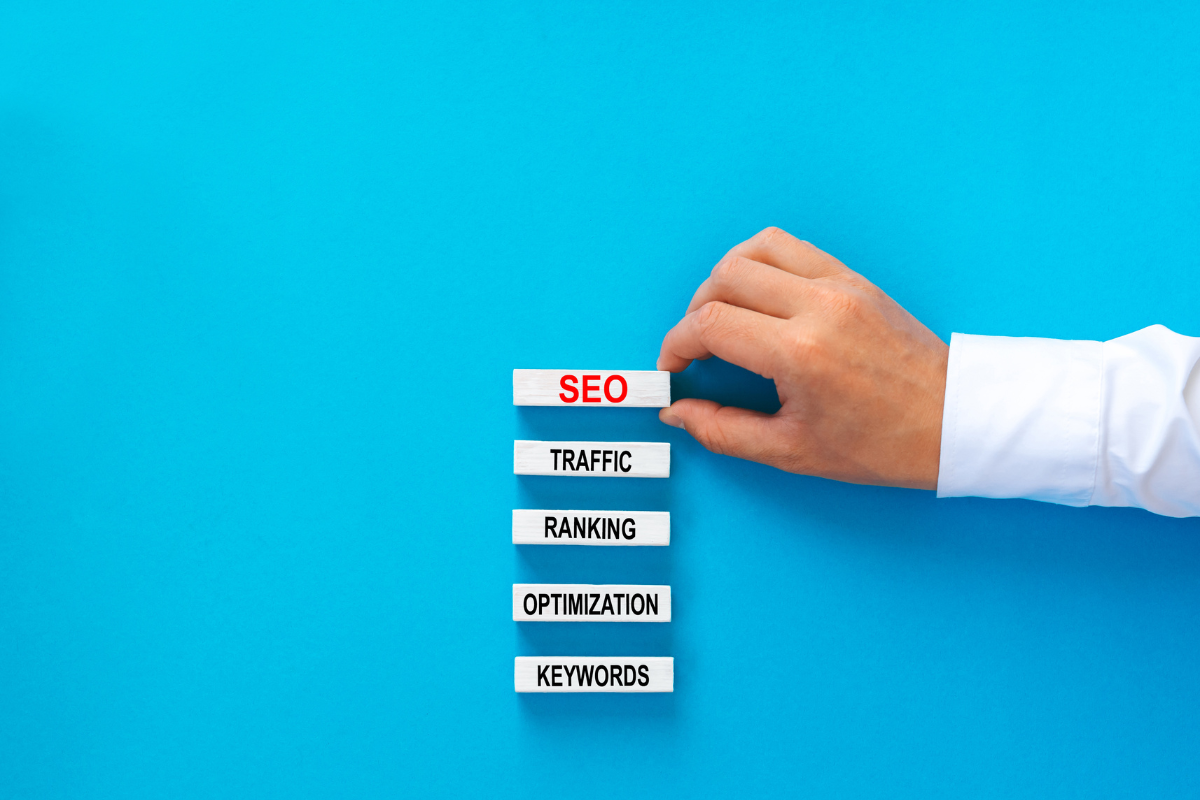 SEO Marketing Strategies: Your Roadmap To Online Success 4 A man is holding an SEO sign on a blue background.