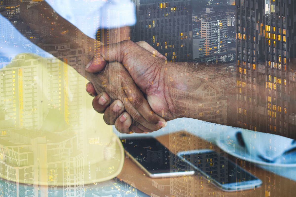Marketing for Construction Companies: Building Your Brand Brick by Brick 2 Two people shaking hands superimposed on an urban skyline at dusk, symbolizing marketing for construction companies.