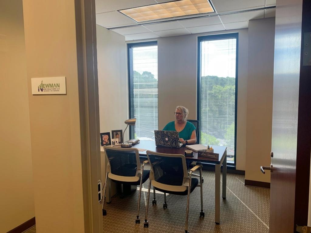 The History of Atlanta, Georgia 4 A woman sitting at a desk in an Atlanta office.