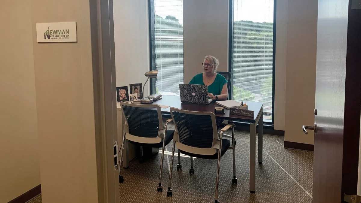RM Locations 1 A woman sitting at a desk in an Atlanta office.