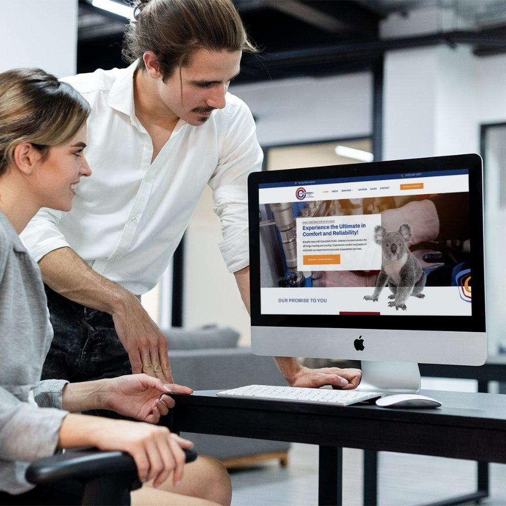 A couple from an HVAC Marketing Agency observing a computer screen featuring a cat.