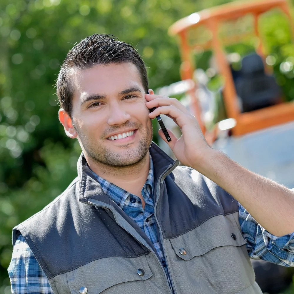 A man on a cell phone handling landscape marketing.