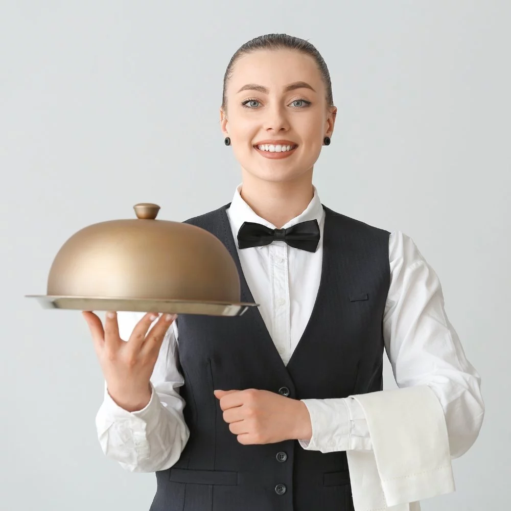 A catering marketing agency showcasing a waitress with a golden platter on a gray background.