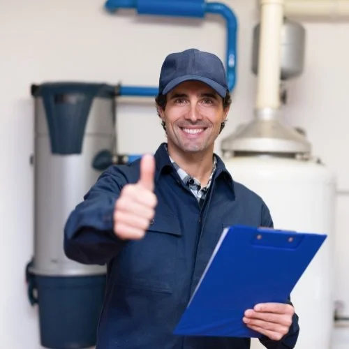 Plumbing Marketing Services 2 A plumber showcasing their expertise and giving a thumbs up in front of a water heater to promote their plumbing marketing services.