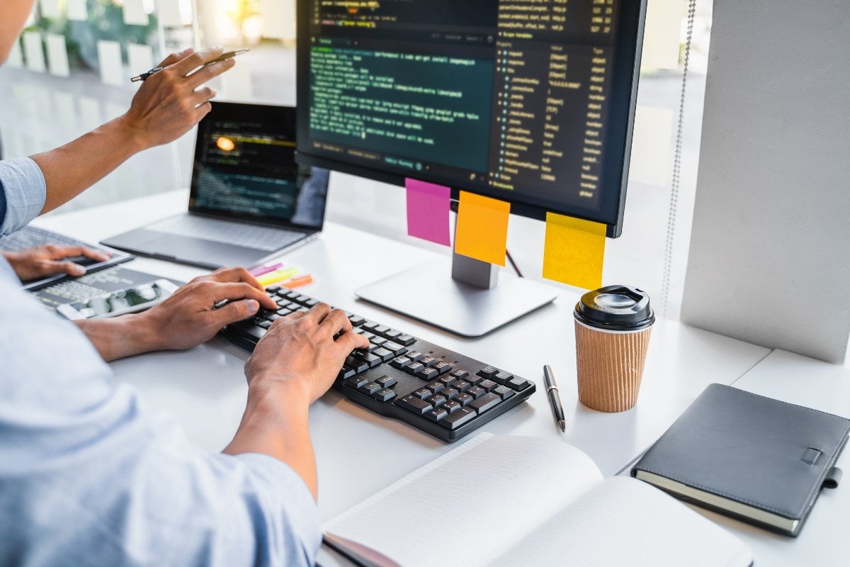 A man is giving a website makeover at his desk.