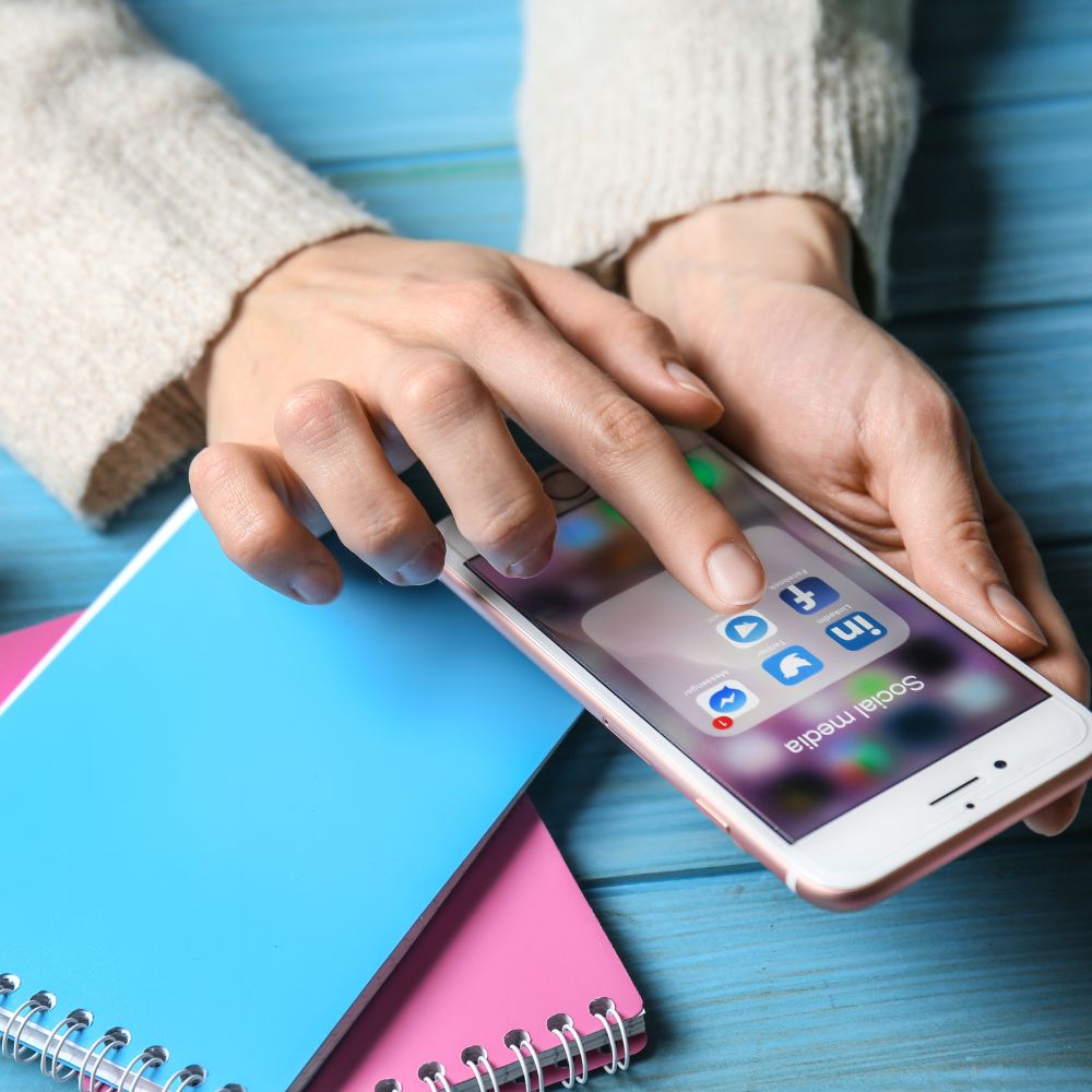 A woman's hand is holding a cell phone for a LinkedIn marketing agency.