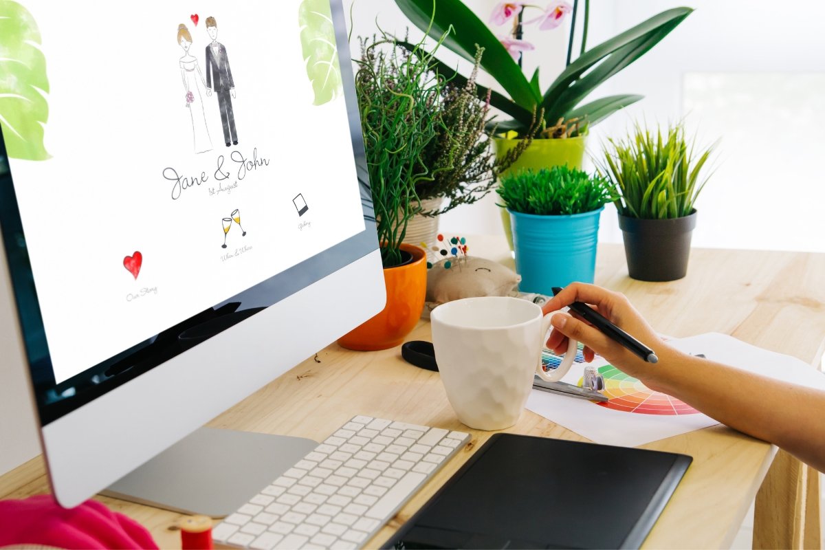 A minimalist woman is sitting at a desk with a laptop computer.