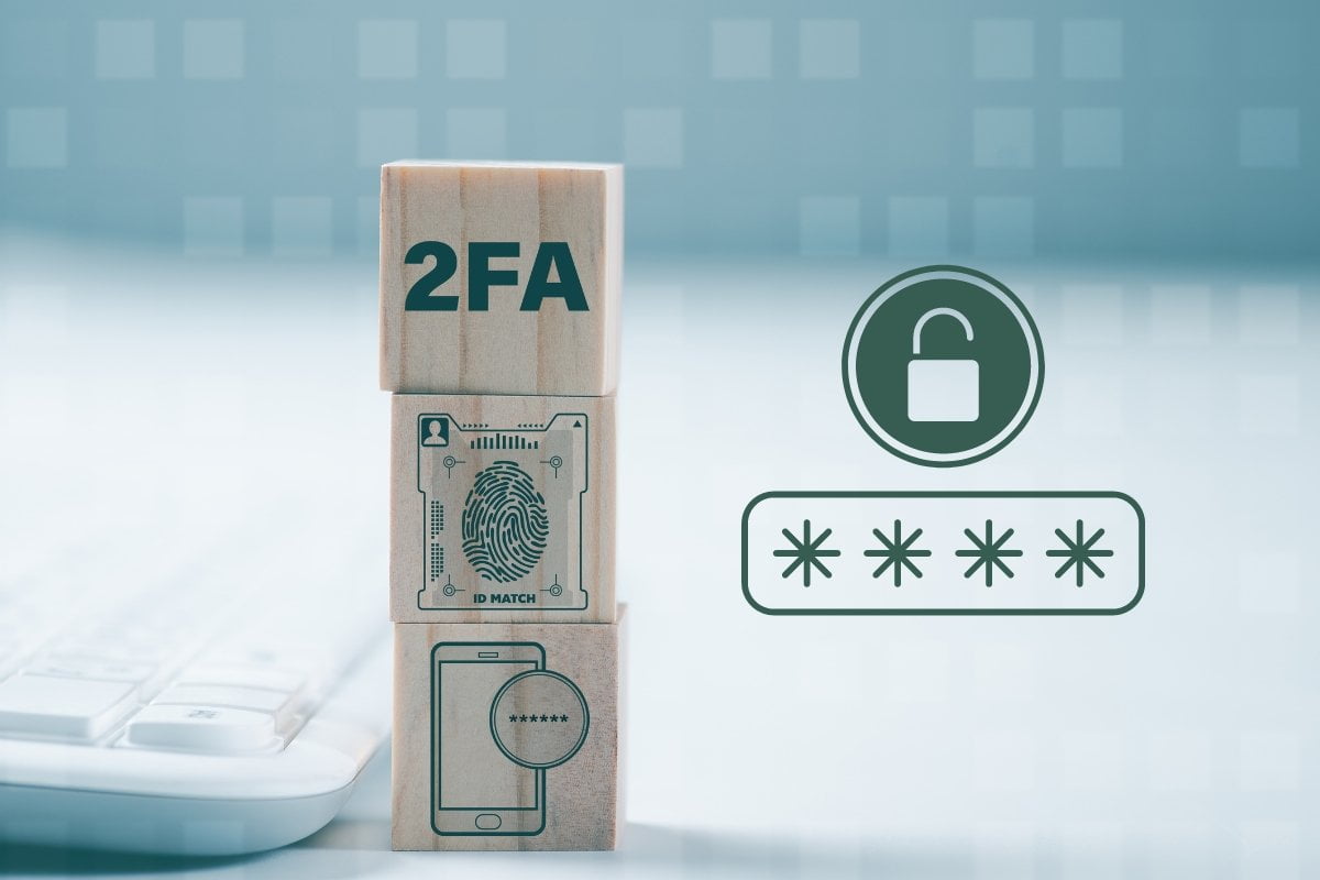 A wooden block with the acronym 2fa on it next to a keyboard.