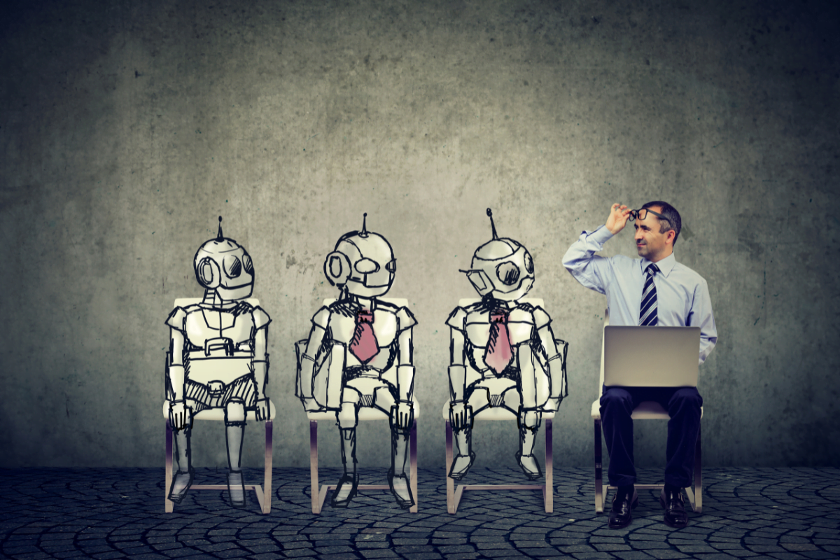 AI In Marketing: Revolutionizing Strategies For Success 2 A man sitting with a group of AI robots.