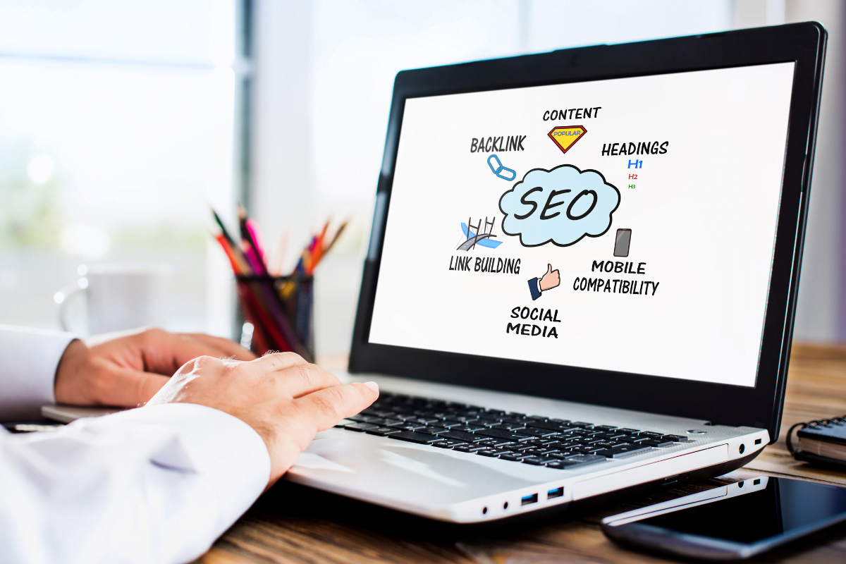 10 Game-Changing Strategies To Skyrocket Your eCommerce Business Success 3 A person using a laptop with "SEO" on it.