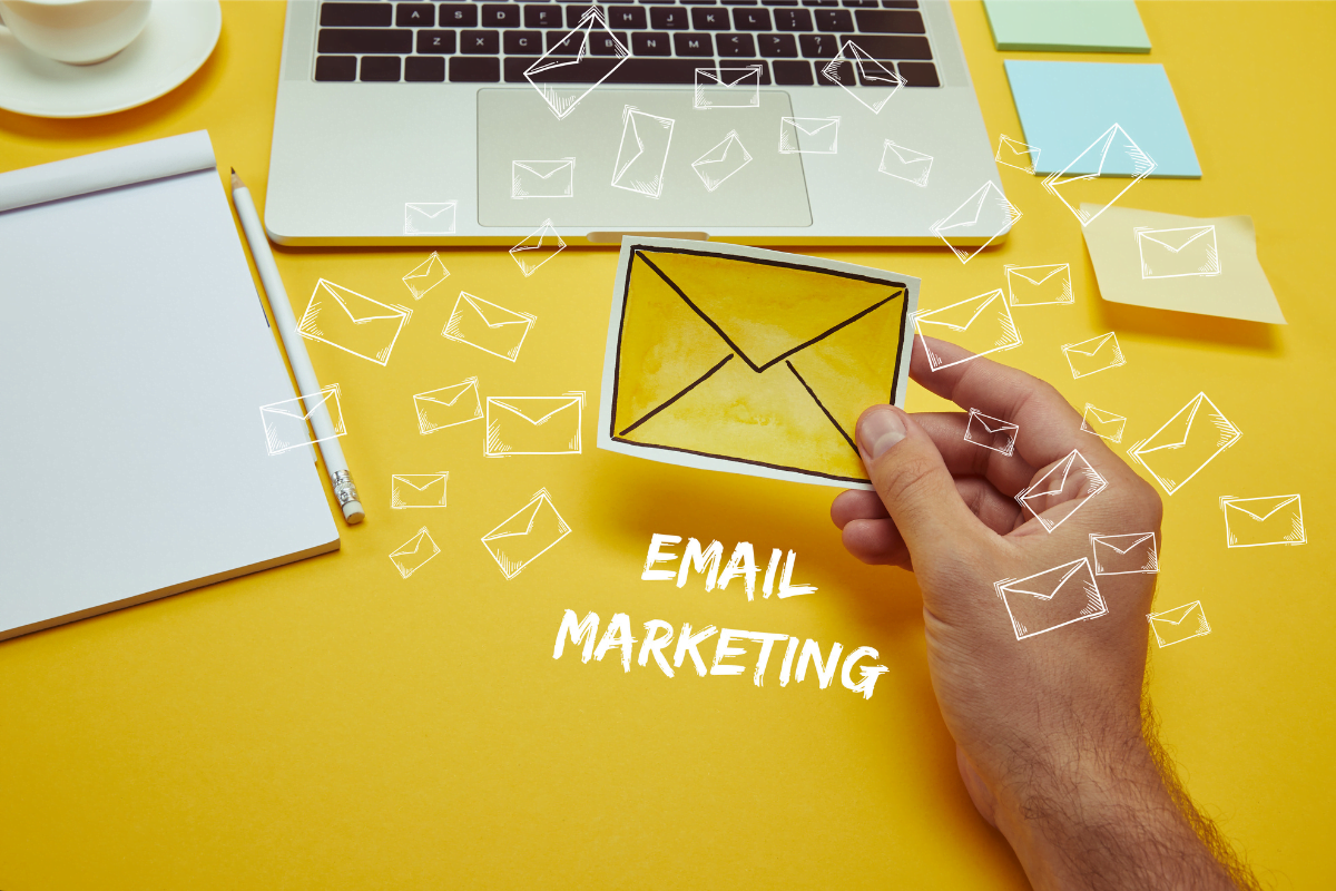 Construction Marketing Strategies: Your Roadmap to Brand Success 7 A hand holding an envelope with the word "email marketing."