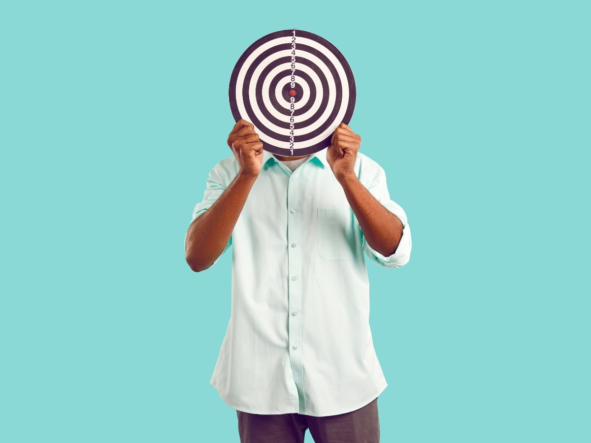 A man demonstrating local seo geo-targeting with a dart board.