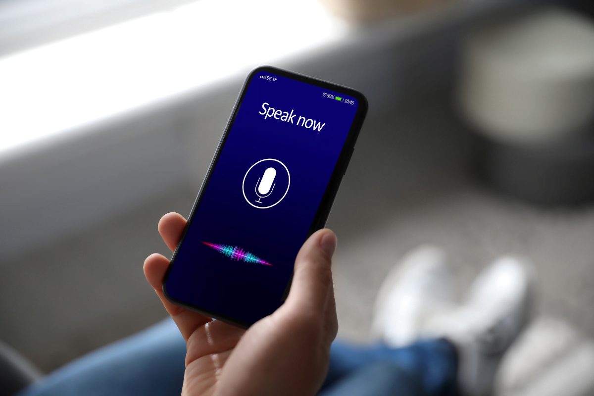 The Power Of Semantic Search In SEO: Cracking The Code 3 A person interacting with a smartphone displaying a voice search.