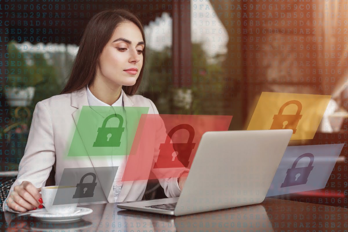 A woman is sitting at a table with a laptop, seemingly unaware of the shadow banning implications brought by the padlocks.