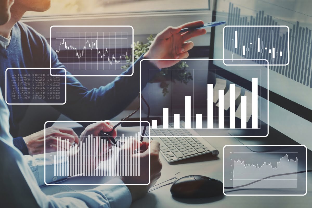 A group of people making data-driven decisions while looking at graphs on a computer screen.
