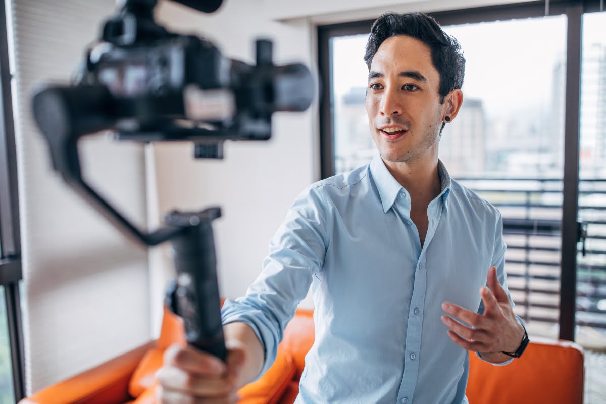The Power of Influencer Marketing: How to Win Over Your Target Audience 3 An influencer recording content with a video camera in his living room.