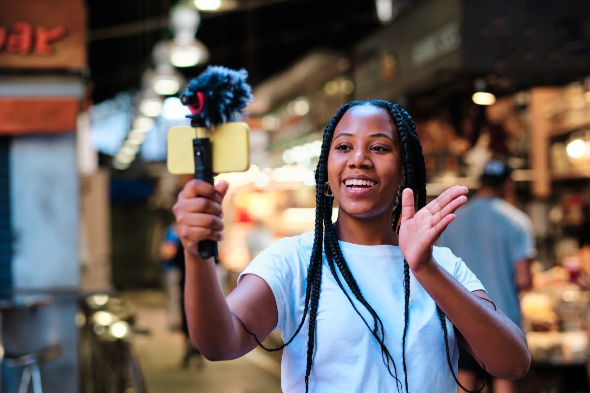 The Power of Influencer Marketing: How to Win Over Your Target Audience 5 An influencer is taking a selfie in a market.