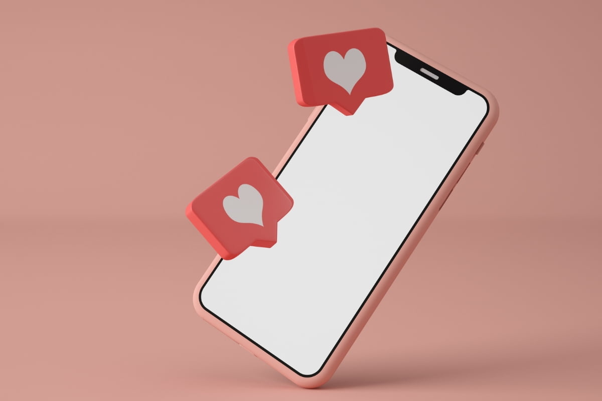 The Pros and Cons of Using Link Shorteners on Social Media 2 A smartphone displaying a heart icon on the screen.