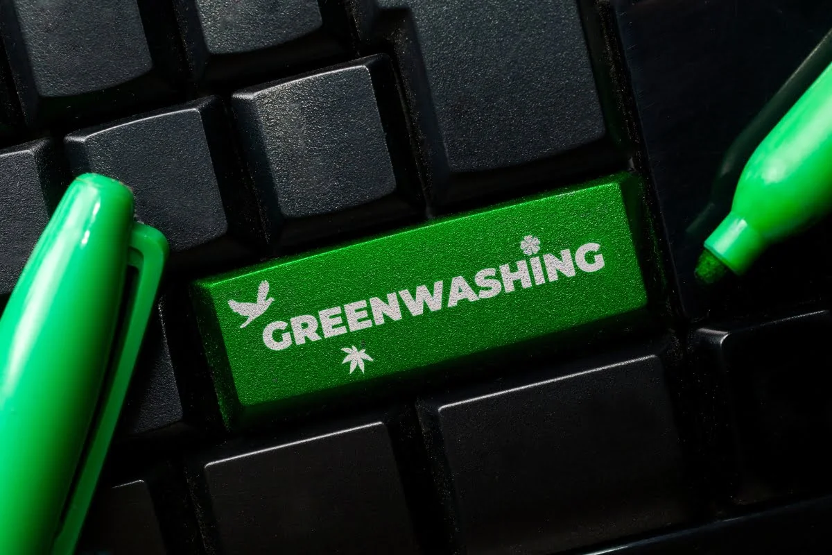A keyboard button adorned with pens, emphasizing the importance of avoiding greenwashing.