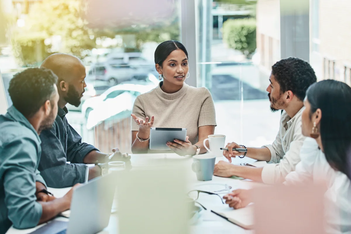 Digital Marketing Agencies For Startups: Unleashing Growth And Success 2 A group of people from digital marketing agencies for startups sitting around a table in a meeting, discussing strategies.