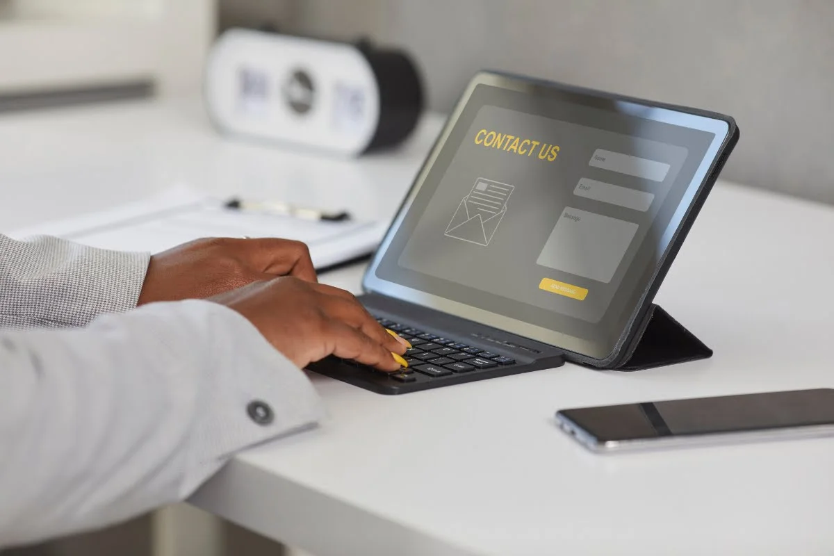 Landing Page Conversions: The Ultimate Guide to Skyrocket Your Sales 7 A person engrossed in typing on a tablet computer, with utmost focus and efficiency.