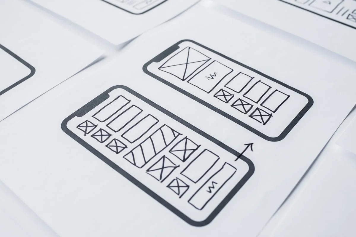 Landing Page Conversions: The Ultimate Guide to Skyrocket Your Sales 9 A sheet of paper featuring drawings of a phone and a tablet, designed to enhance landing page conversions.