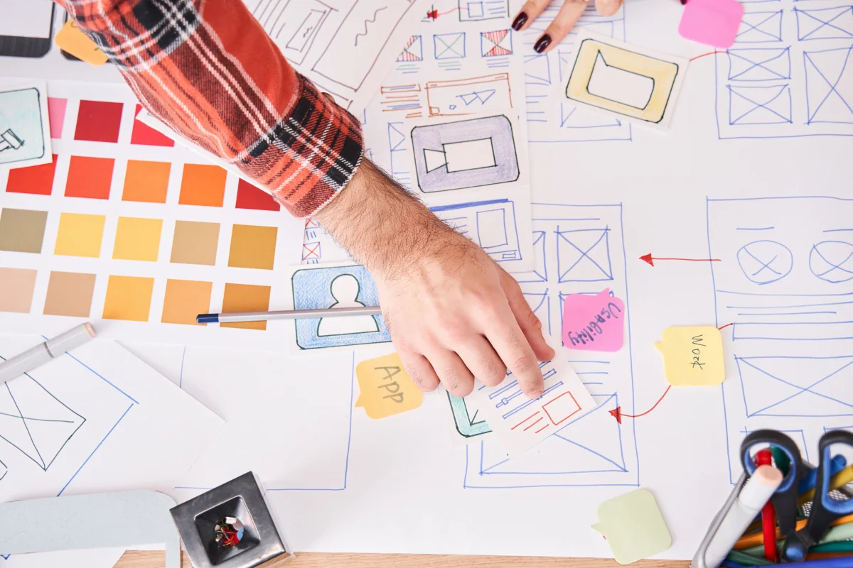 Landing Pages That Convert: The Power Of High-Converting Design 2 A group of people working on a design project focused on creating landing pages that convert.