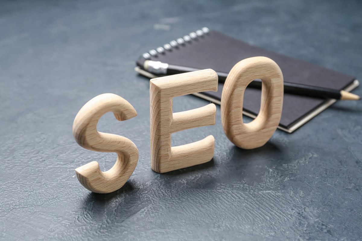 The word SEO spelled out in wooden letters, a vital component of digital marketing.