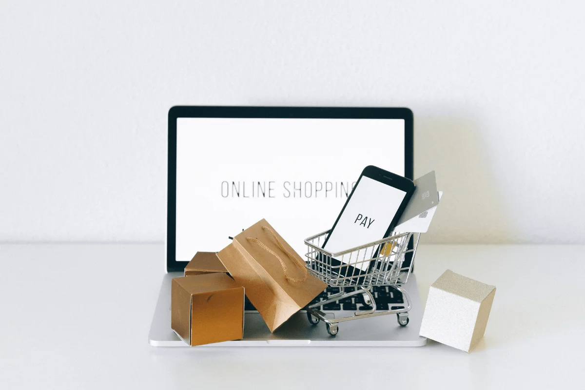 Social Proof Marketing: Boost Your Brand With Trustworthy Validation Techniques 2 A laptop showcasing social proof marketing strategies, with a shopping cart symbolizing conversion.