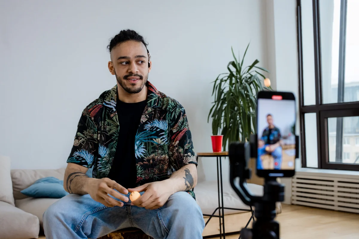 Short Video Content Strategy: Compelling Clips for Maximum Engagement 2 A man strategically filming short content in his living room using his phone.