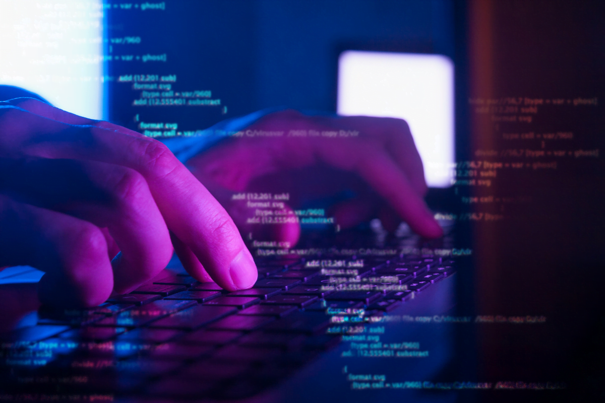 A person engaged in WordPress development tips, typing on a computer keyboard at night.